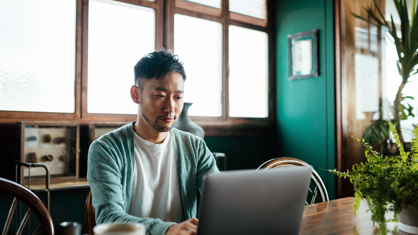 Man sitting at laptop looking online