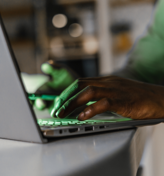 Hands typing on laptop
